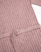 7AM Hug Me ribbed knit dress in ash rose, close-up of fabric texture and belt detail on flat surface.