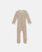 7AM Hug Me Ribbed Knit Romper in beige with long sleeves, laid flat on a white background.