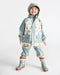Kids rain jacket and pants set with pastel house print, shown on a smiling child in boots