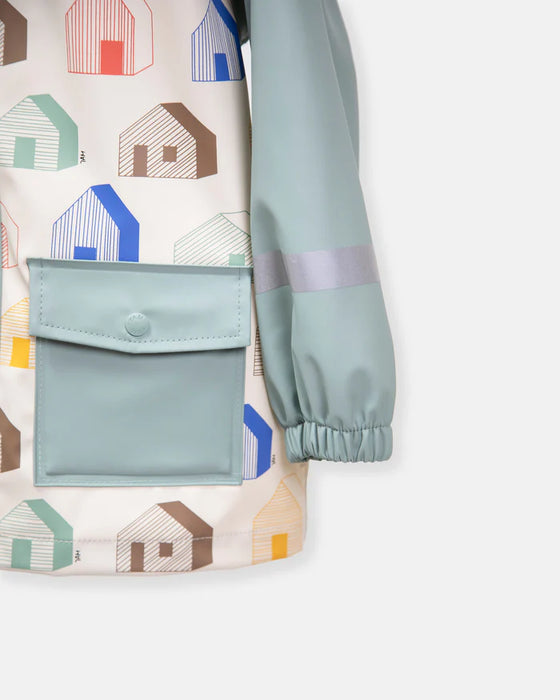 Children’s rain jacket with light blue sleeve, large front pocket, and colorful house print.