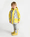 Child wearing a yellow and grey star-patterned rain jacket and matching rain boots on a white background.