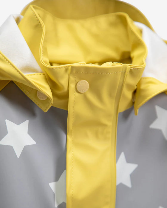 Yellow and grey 7AM rain jacket with star print, close-up of collar and front snaps.