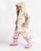 Kids rain jacket with colorful tree print and pink accents shown worn by a child indoors.