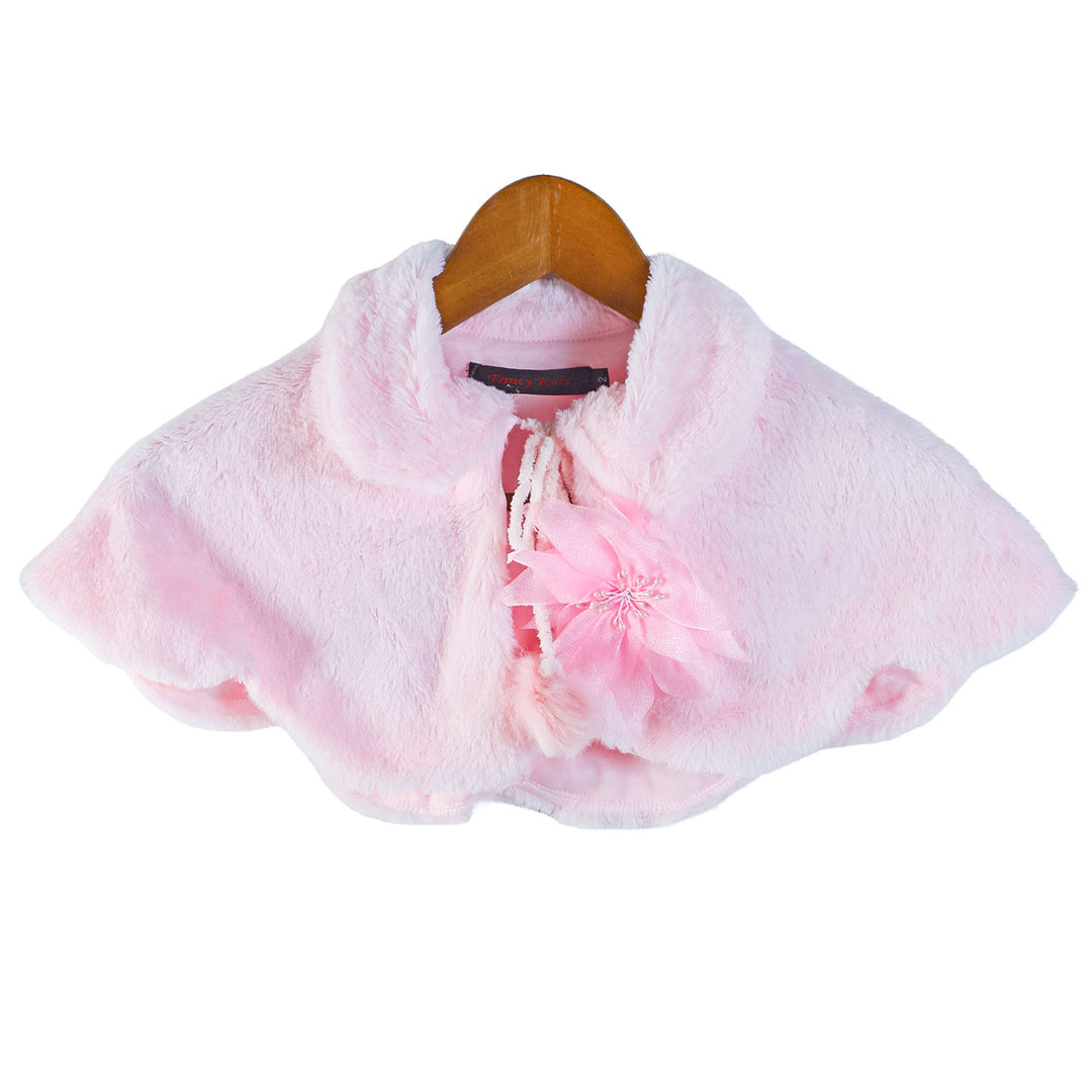 Baby pink faux fur bolero with pompom cords and floral detail displayed on a wooden hanger.