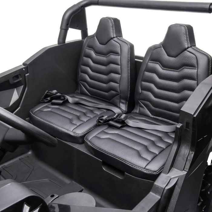 Kids ride-on car black interior with two seats and seat belts, shown from above.
