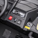 Ride-on toy car dashboard close-up with control switches, USB port, and labeled socket.