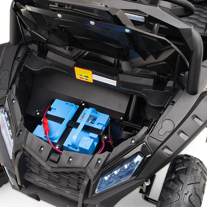 Kids ride-on car battery compartment shown with the hood open and blue batteries installed.
