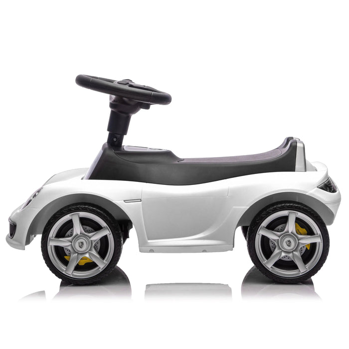 White ride-on toy car for kids on a white background, side profile showing wheels and steering wheel.