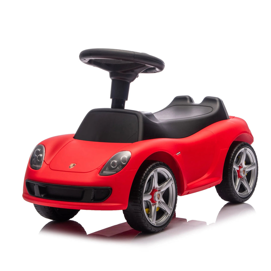 Red kids ride-on car toy with black seat and steering wheel shown on a white background.
