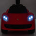Red Porsche kids ride-on car toy with headlights turned on, front view against a plain background.