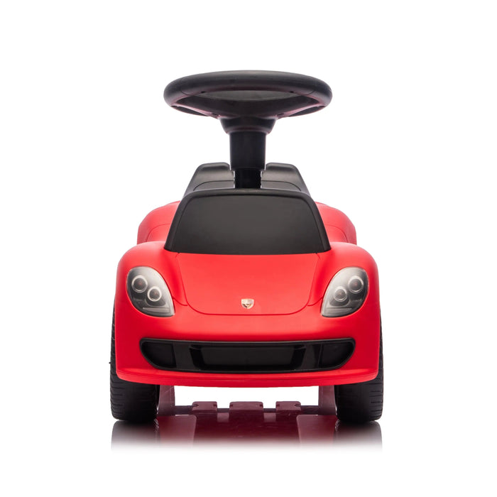 Red ride-on toy car for kids shown from the front with a steering wheel and detailed headlights.