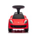 Red ride-on toy car for kids shown from the front with a steering wheel and detailed headlights.