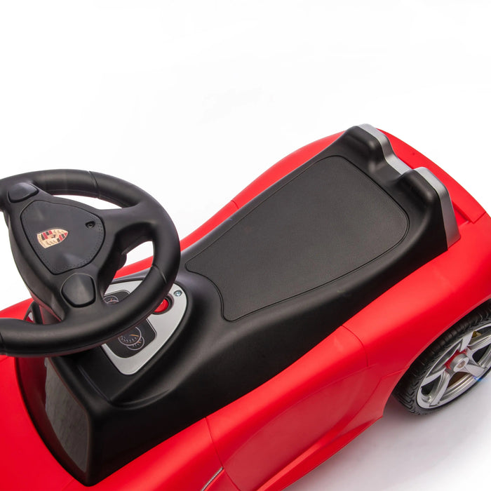 Porsche kids ride-on car top view showing black seat and steering wheel on white background.