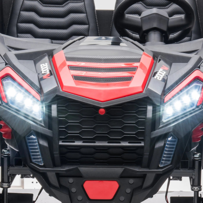 Kids ride-on car close-up showing red and black front grille, headlights, and steering wheel.