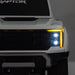 Toy Ford Raptor truck front view with illuminated LED headlights and detailed grille.