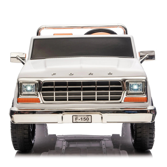 Ford F-150 kids ride-on toy truck in white shown from the front with headlights on.