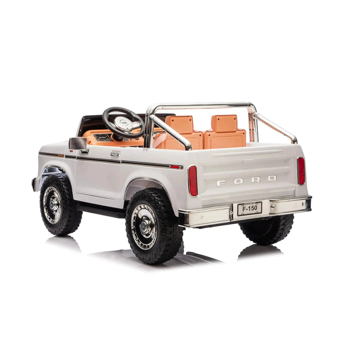 Kids Ford F-150 ride-on toy truck shown from the rear, featuring white exterior and tan seats.