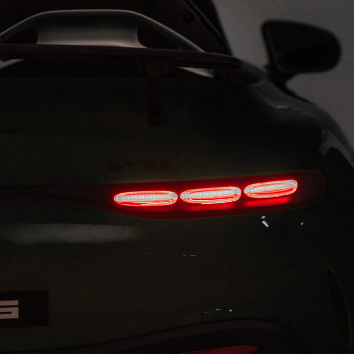 Children’s ride-on car tail light illuminated in a dark indoor setting.
