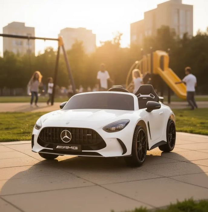 Mercedes AMG kids ride-on car parked on playground pavement with children playing in the background.