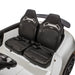 Children’s ride-on car with two black seats and safety belts shown in a close-up interior view.
