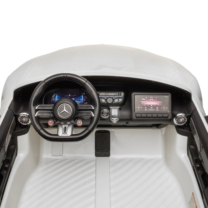 Kids ride-on Mercedes dashboard with steering wheel, control panel, and touchscreen display.