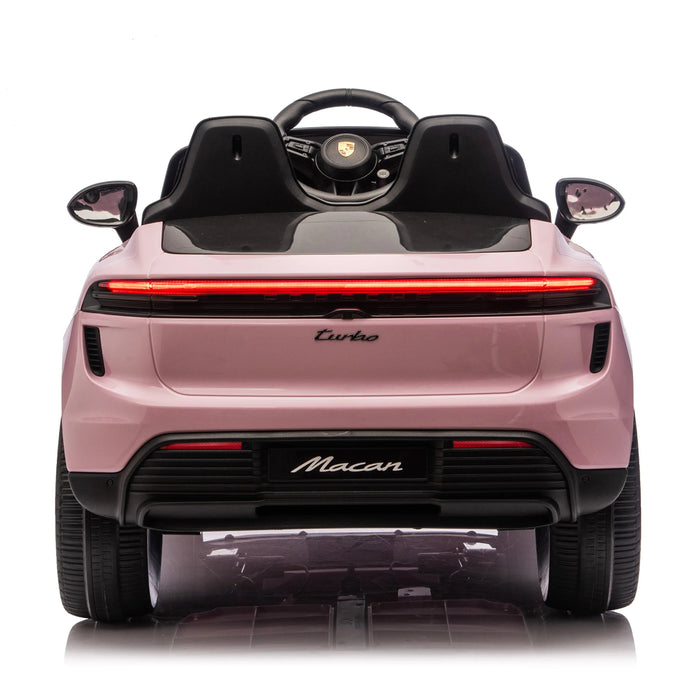 Porsche Macan kids ride-on car in pink shown from the rear against a white background.