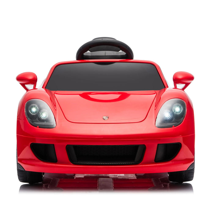 Kids red ride-on electric sports car with working headlights shown from the front on a white background.