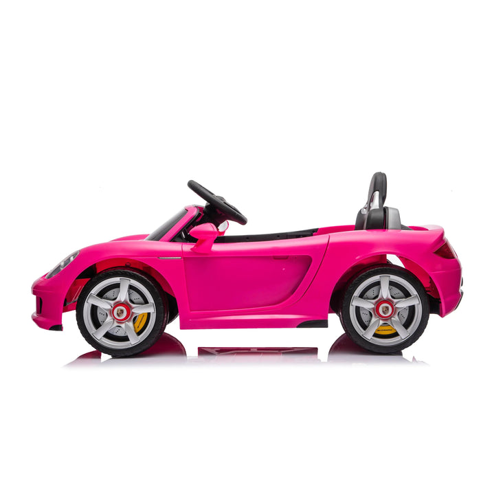 Kids pink ride-on toy car with steering wheel and seat shown on a white background.