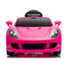 Pink ride-on toy car for kids shown from the front with headlights on against a white background.