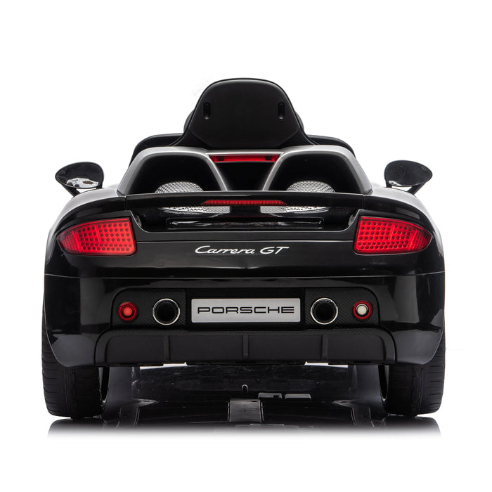 Porsche Carrera GT ride-on toy car in black shown from the rear with red tail lights visible.