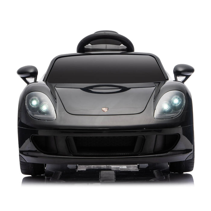 Black kids ride-on car with LED headlights shown from the front on a white background.