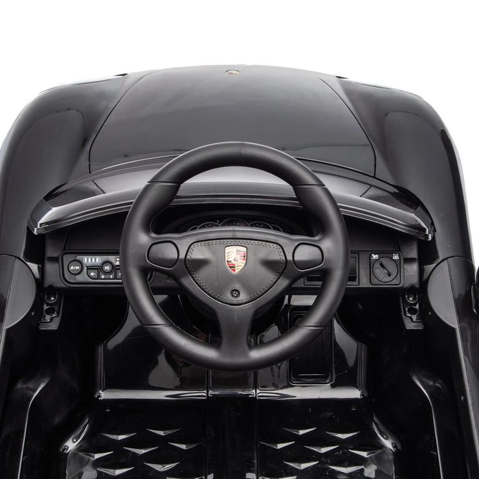 Porsche ride-on toy car steering wheel and dashboard close-up for kids.