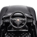 Porsche ride-on toy car steering wheel and dashboard close-up for kids.