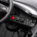 Kids’ ride-on toy car dashboard with steering wheel, speed controls, and ignition switch visible.