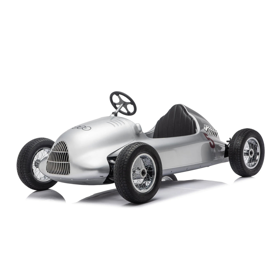 Kids silver pedal car styled like a vintage race car, shown on a white studio background.