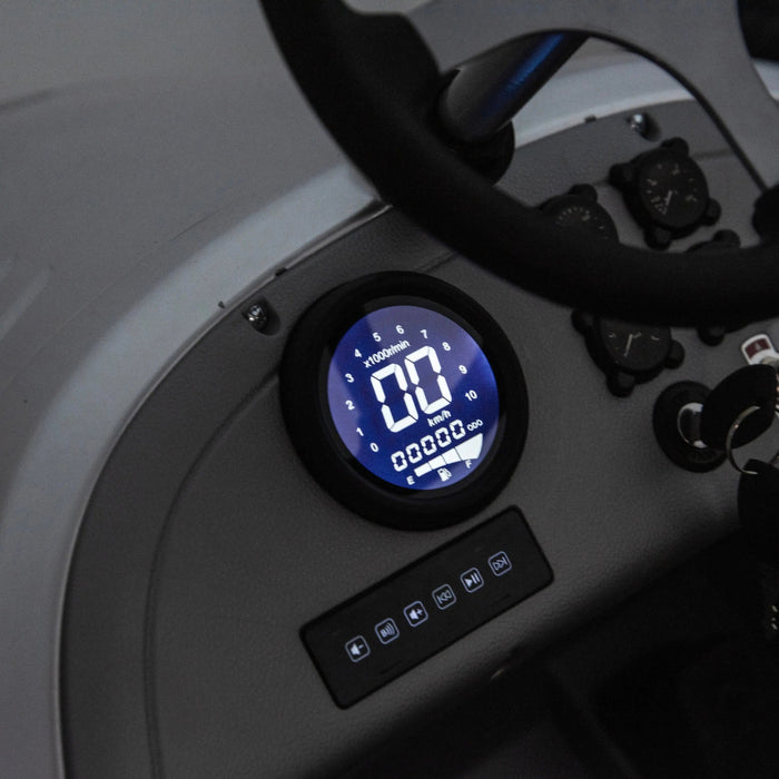 Kids ride-on car dashboard with illuminated digital speedometer and controls close-up.