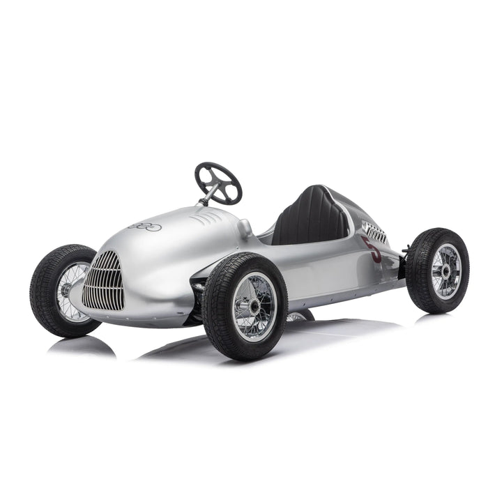 Kids silver pedal car styled like a vintage race car, shown on a white studio background.