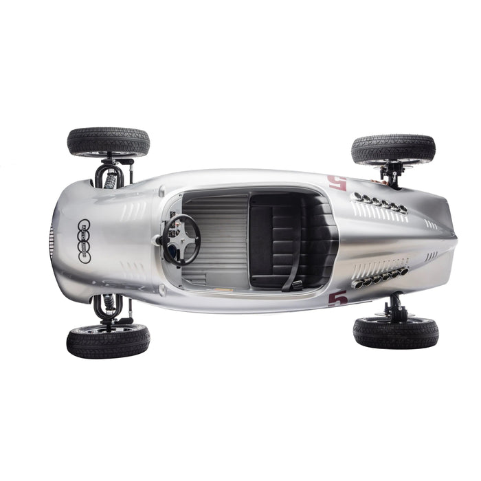 Children’s silver ride-on race car toy shown from above on a white background.