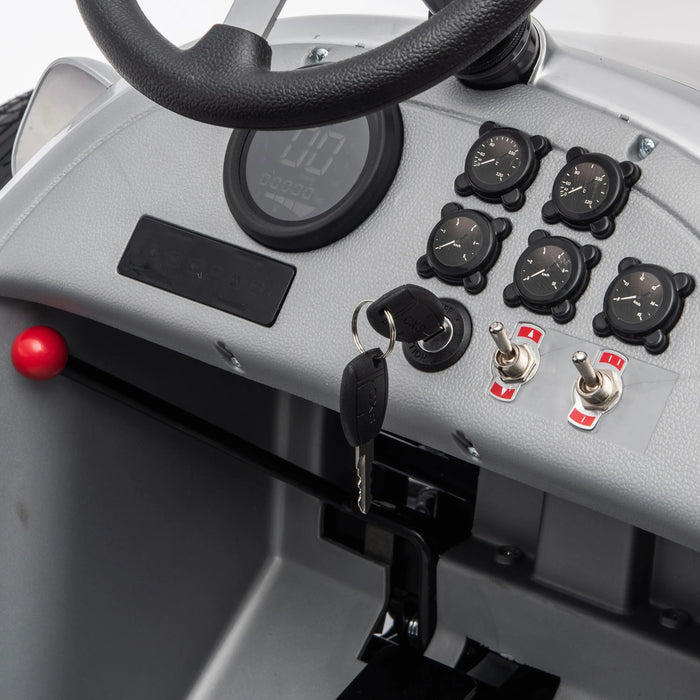 Kids ride-on car dashboard featuring steering wheel, ignition key, gauges, and control switches.