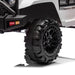 Kids ride-on toy car close-up showing rugged black wheel and front bumper detail on white background.