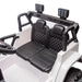 Kids ride-on car with two black quilted seats and steering wheel shown in close-up view.