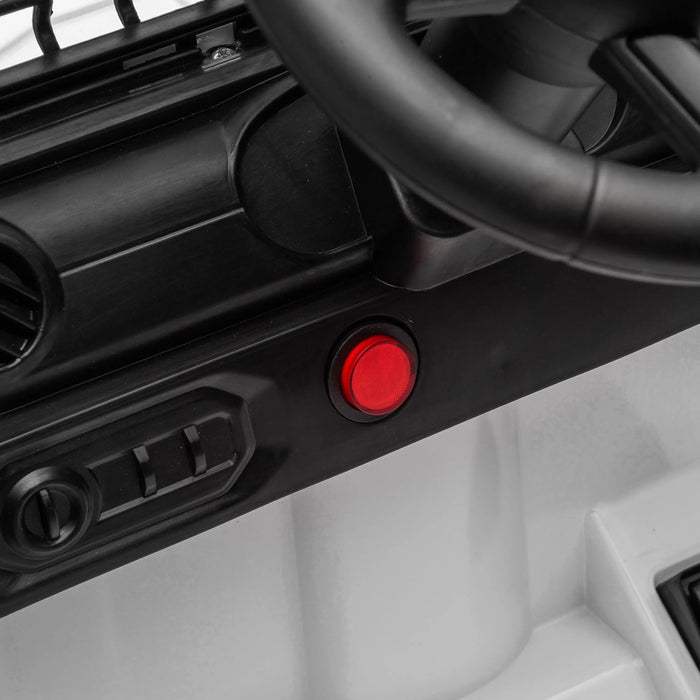 Kids ride-on car dashboard close-up with red power button and steering wheel visible.