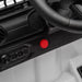 Kids ride-on car dashboard close-up with red power button and steering wheel visible.