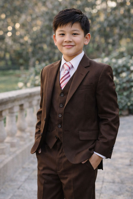 Brown teen boy suit with vest and striped tie, modeled outdoors near a stone railing.
