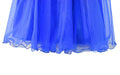 Blue glitter dress for kids with layered tulle skirt shown in close-up on white background.
