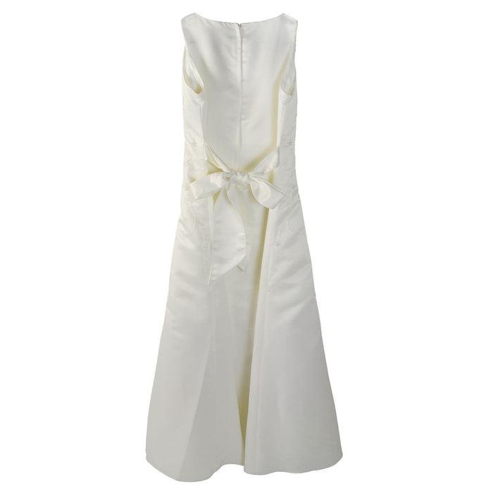 Ivory flower girl party dress with bow detail shown from the back on a white background.