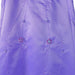 Lilac flower girl party dress with sequin floral embroidery and bead accents, shown close up.