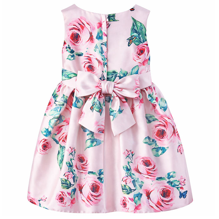 Girls' pink silky dress with rose and butterfly print, shown from the back with a large bow detail.