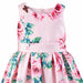Kids silky pink dress with roses and butterfly print shown on a flat white background.