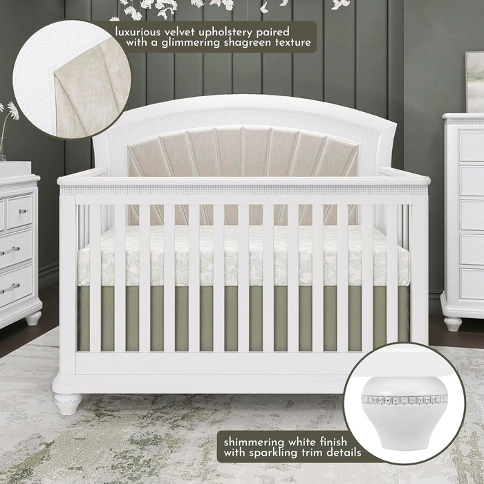 White baby crib with velvet upholstered headboard, shimmering finish, and sparkling trim in a modern nursery.